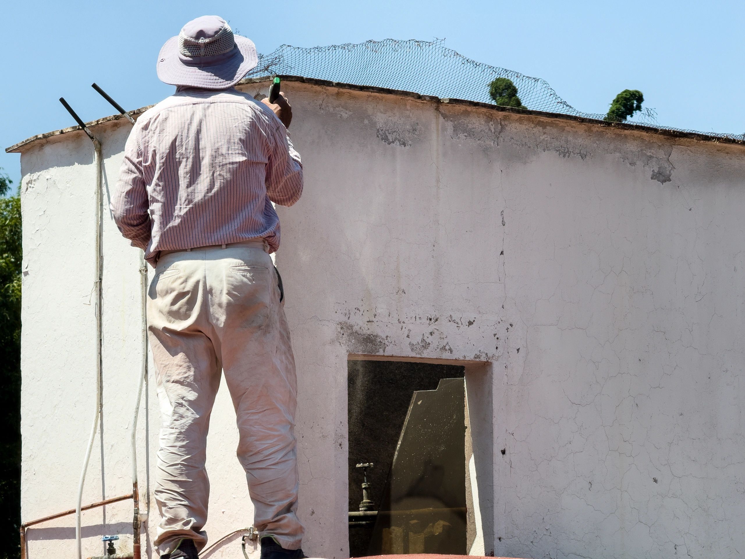 Technician performing chimney and rooftop service