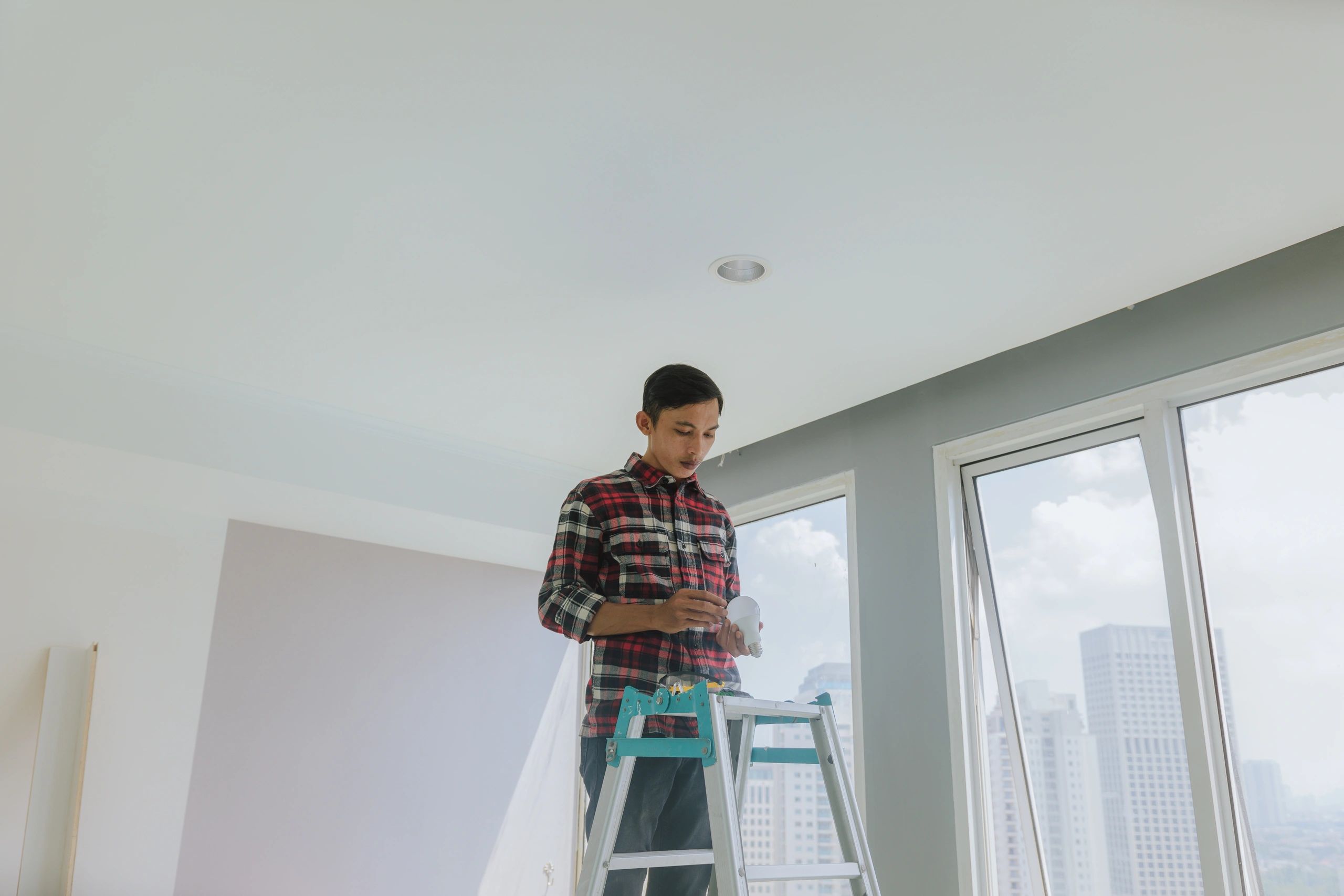 Technician servicing home ventilation equipment